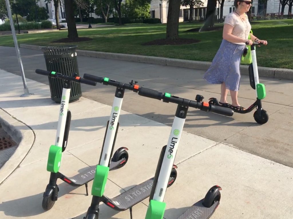 a women using a Lime Scooter