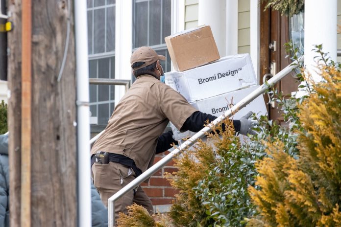 a man delivering packages for money