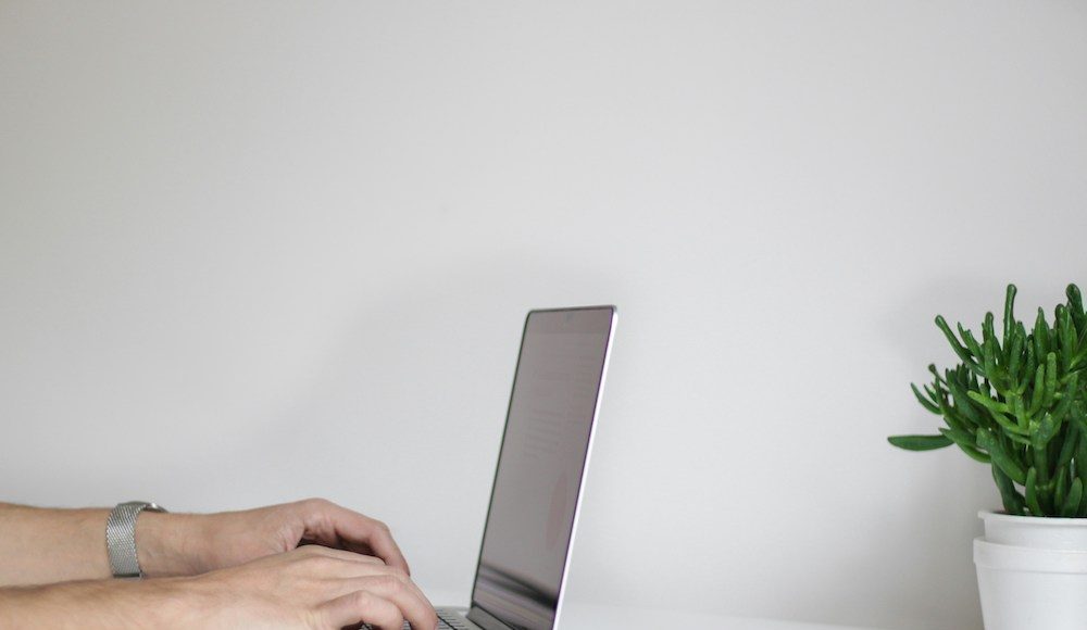 photo of person typing on laptop