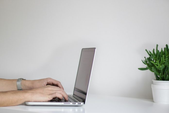 photo of person typing on laptop